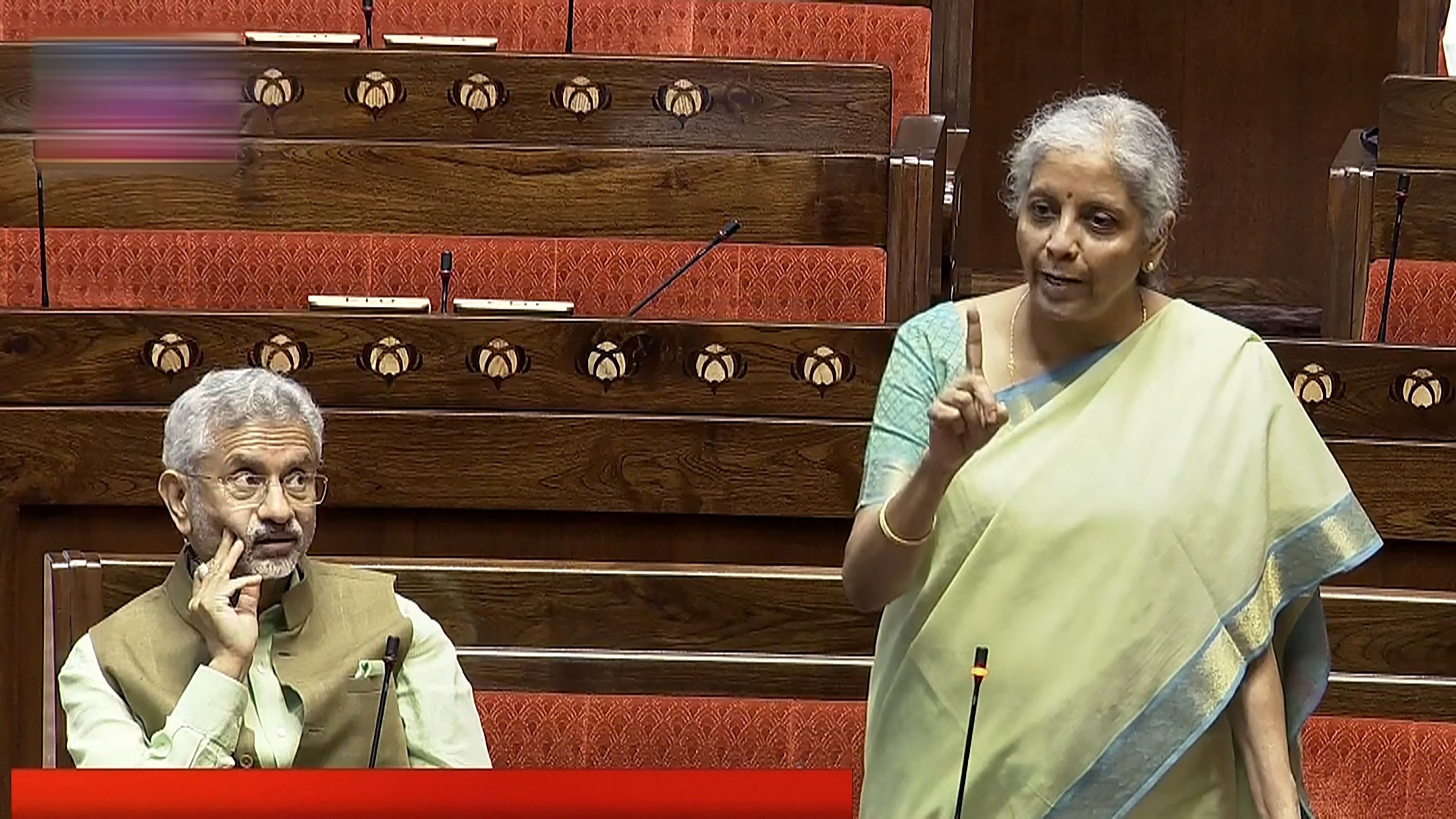 <div class="paragraphs"><p>Union Finance Minister Nirmala Sitharaman speaks as External Affairs Minister S. Jaishankar looks on in the Rajya Sabha during the Monsoon session of Parliament, in New Delhi, Wednesday.</p></div>